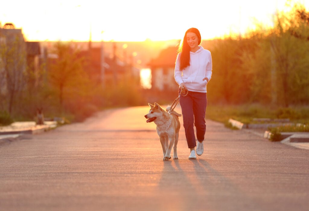 teenager walking dog