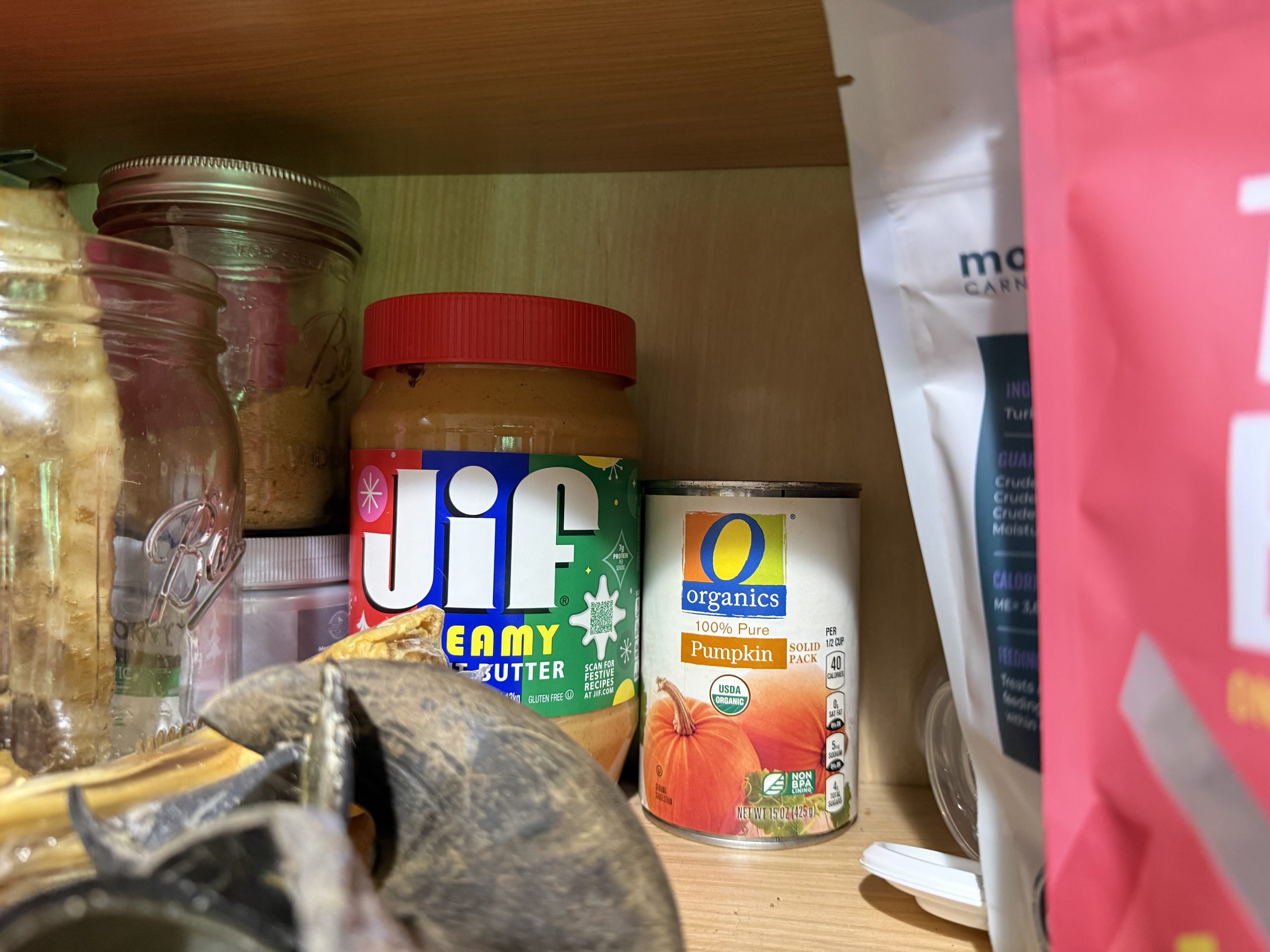 Dog treat cupboard with peanut butter used for Kong enrichment
